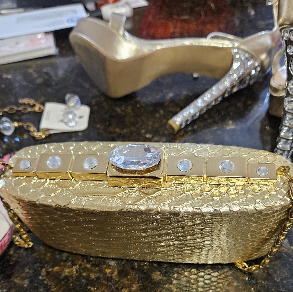 Elegant Gold Clutch with Textured Surface and Sparkling Embellishments